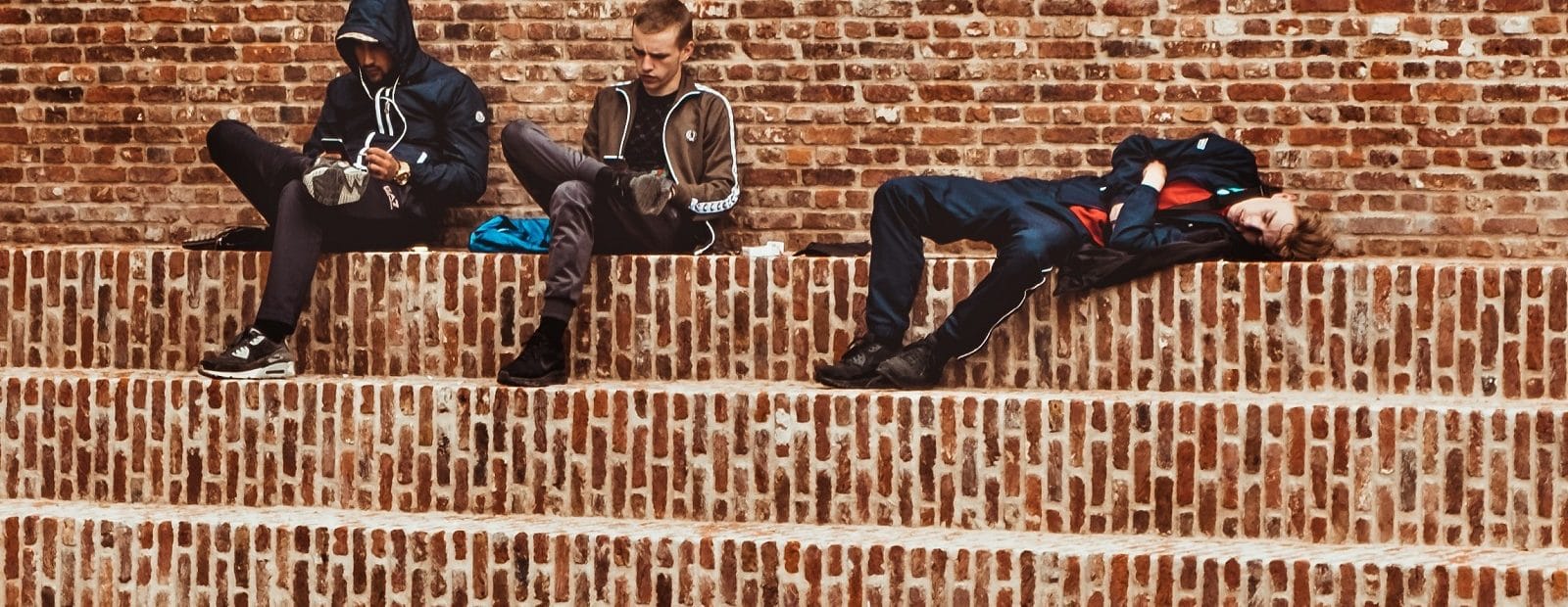 teinejä lojumassa portailla